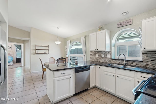 kitchen with appliances with stainless steel finishes, hanging light fixtures, kitchen peninsula, white cabinets, and sink