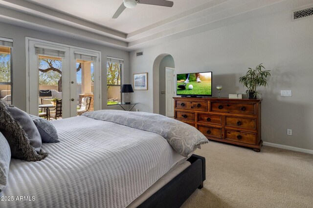 bedroom featuring visible vents, carpet floors, arched walkways, access to exterior, and french doors
