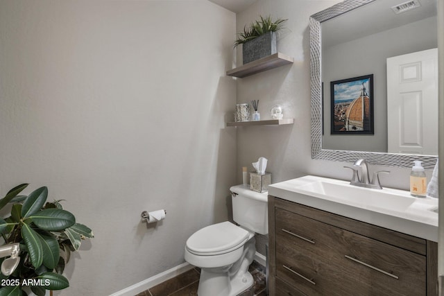 bathroom featuring visible vents, toilet, tile patterned flooring, baseboards, and vanity