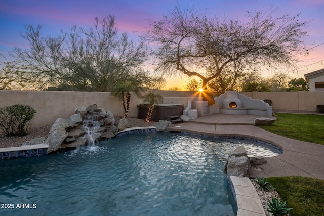 view of pool featuring a patio area, an outdoor fireplace, a fenced backyard, and a fenced in pool
