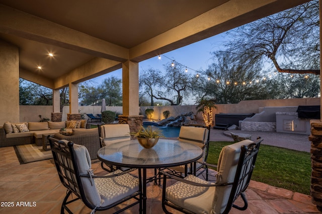 view of patio / terrace with an outdoor living space, outdoor dining area, a fenced backyard, and an outdoor kitchen