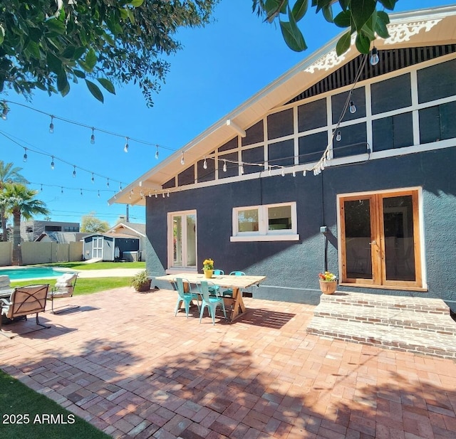 view of patio featuring french doors and fence