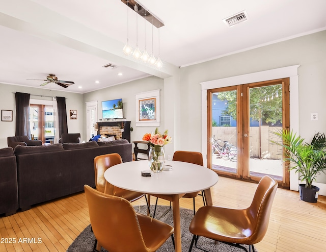 dining space with recessed lighting, visible vents, light wood-style flooring, and crown molding