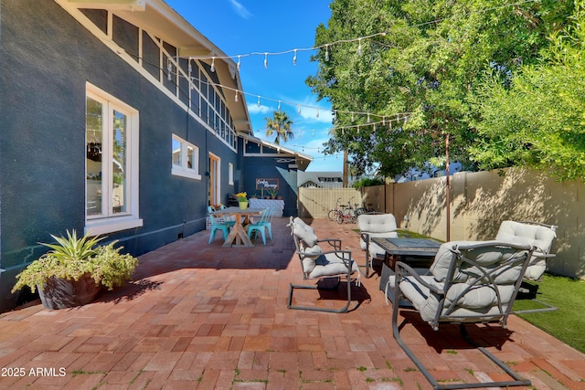 view of patio with outdoor dining space and a fenced backyard