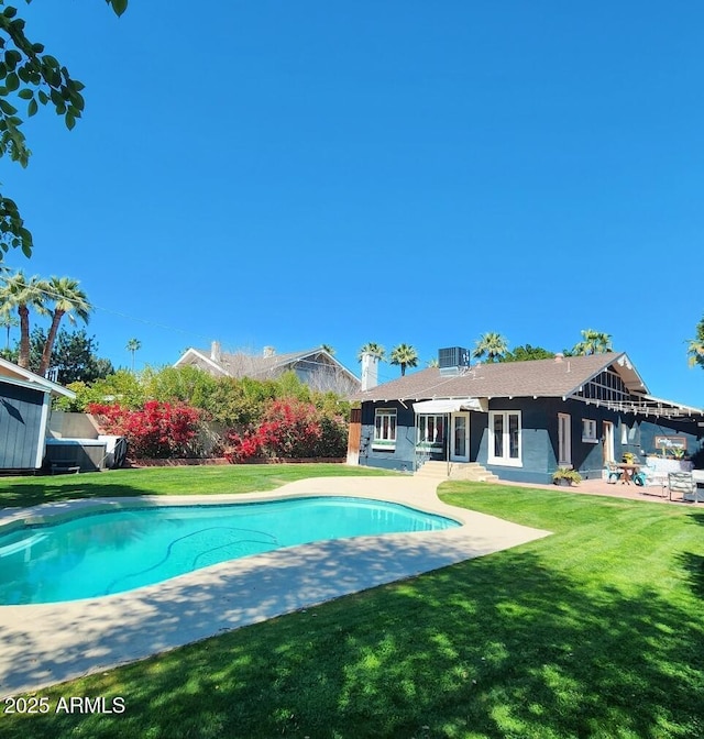 outdoor pool featuring french doors, fence, a lawn, and a patio area