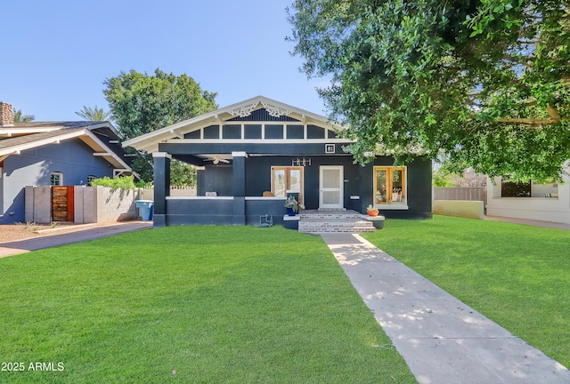 view of front of property with a front yard and fence