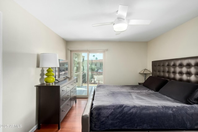 bedroom featuring access to exterior, ceiling fan, and dark wood-type flooring