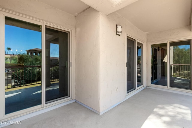 doorway to property featuring stucco siding