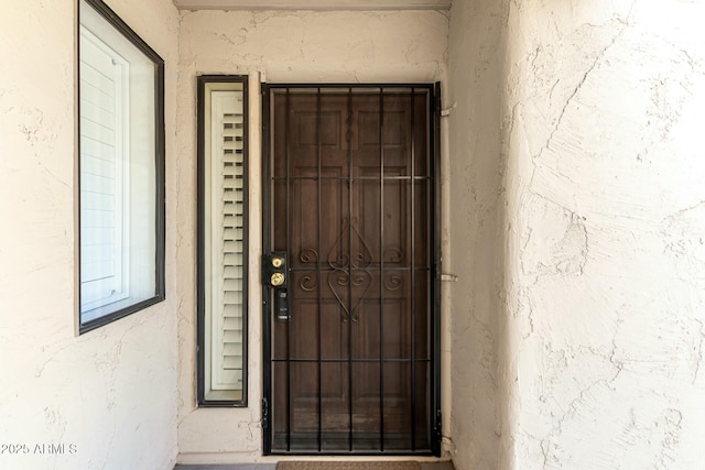 property entrance with stucco siding