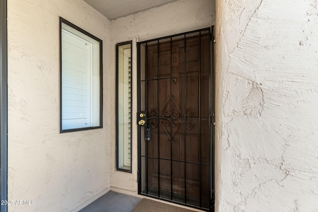 property entrance with stucco siding