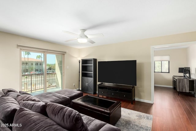 living room featuring dark wood-style floors, a wealth of natural light, ceiling fan, and baseboards