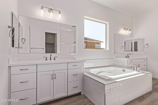 20274 W Monterey Way, Buckeye, AZ 85396 - full bathroom featuring vanity, a garden tub, and wood finished floors