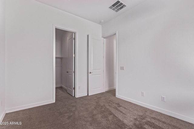 20274 W Monterey Way, Buckeye, AZ 85396 - unfurnished bedroom featuring a walk in closet, carpet, and a closet