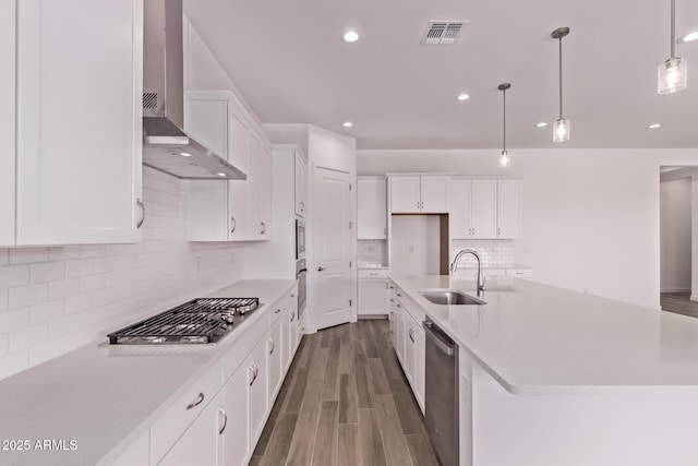 20274 W Monterey Way, Buckeye, AZ 85396 - kitchen featuring wall chimney exhaust hood, stainless steel appliances, dark wood-style flooring, white cabinets, and light countertops