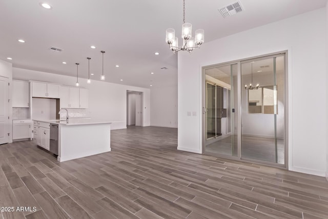 20274 W Monterey Way, Buckeye, AZ 85396 - kitchen featuring a chandelier, open floor plan, light wood-style flooring, white cabinets, and recessed lighting