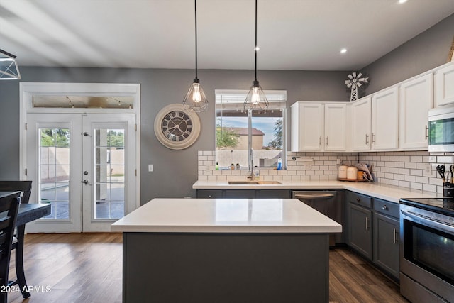 kitchen featuring french doors, white cabinetry, sink, and a kitchen island