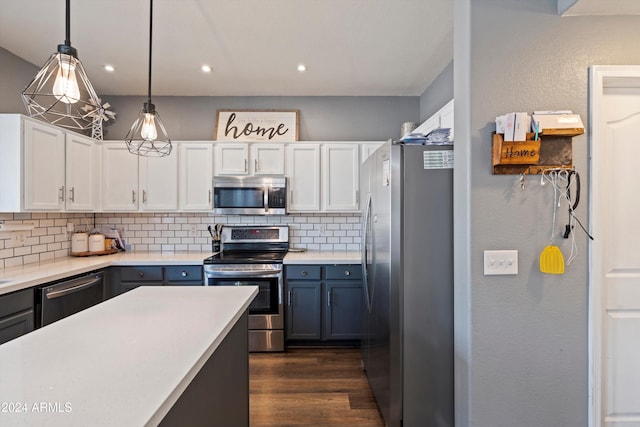 kitchen featuring white cabinets, appliances with stainless steel finishes, hanging light fixtures, and backsplash