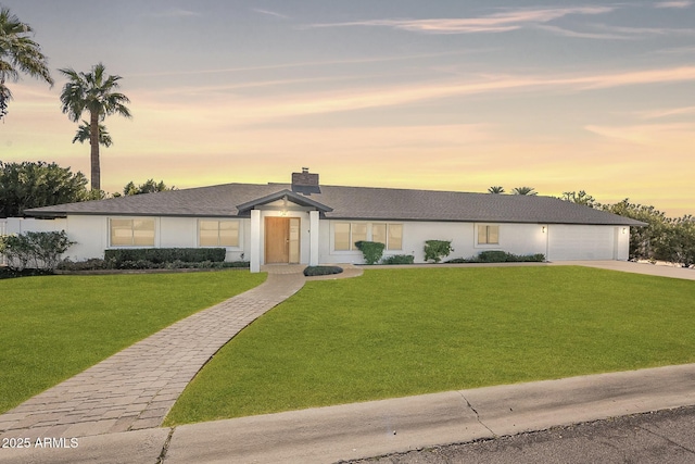 1911 E Claremont St, Phoenix, AZ 85016 - view of front of property featuring an attached garage, a front lawn, stucco siding, a chimney, and driveway