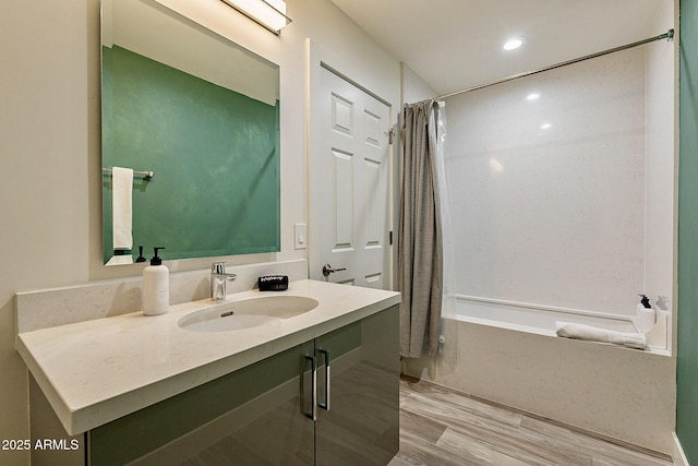 1911 E Claremont St, Phoenix, AZ 85016 - bathroom with vanity, recessed lighting, wood finished floors, and shower / tub combo