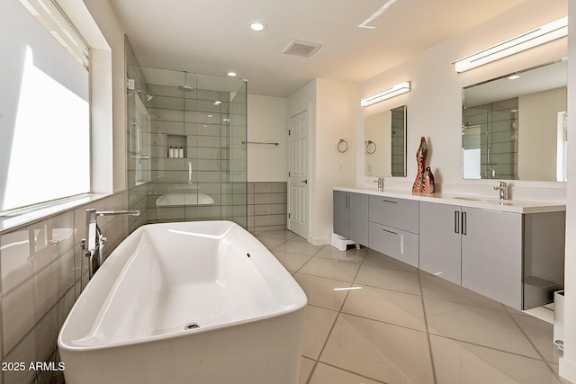 1911 E Claremont St, Phoenix, AZ 85016 - full bathroom featuring double vanity, tile walls, a soaking tub, a sink, and a stall shower