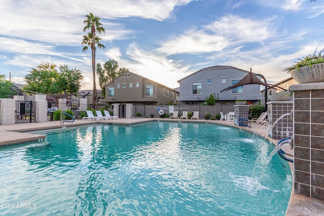 view of swimming pool with pool water feature