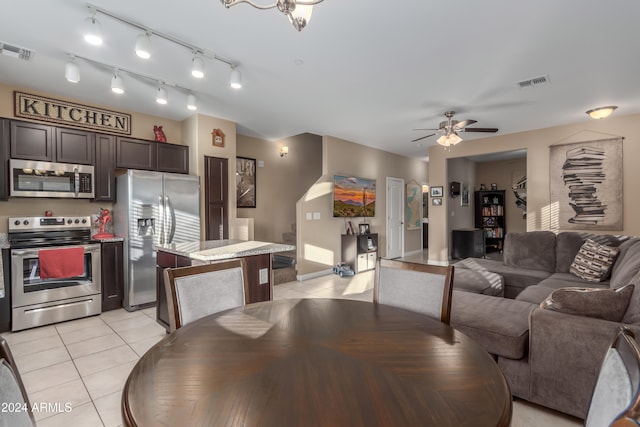 dining room with light tile patterned floors and ceiling fan