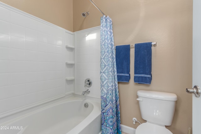 bathroom with shower / bath combo with shower curtain and toilet