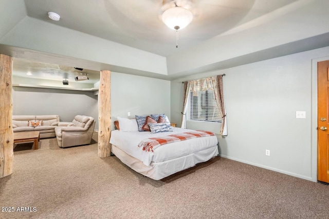 carpeted bedroom featuring a ceiling fan, a tray ceiling, and baseboards