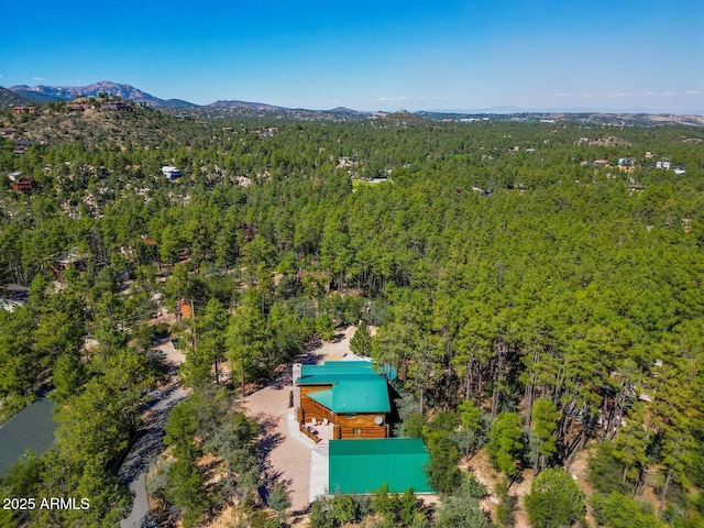birds eye view of property with a mountain view and a forest view