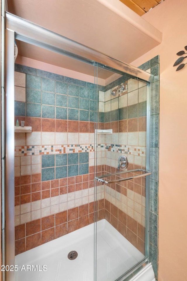 full bath with a shower stall