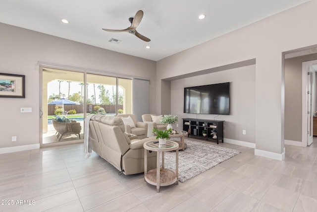 tiled living room featuring ceiling fan