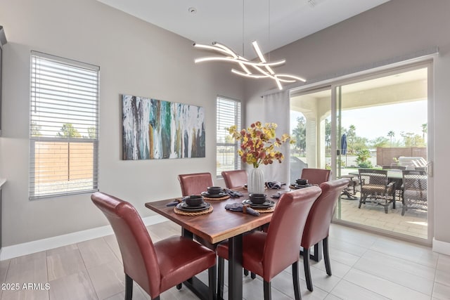 dining room with light tile patterned floors and a notable chandelier