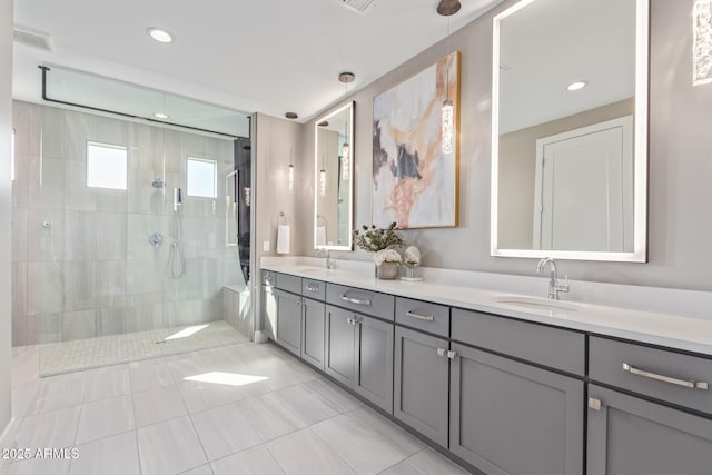 bathroom with vanity and tiled shower