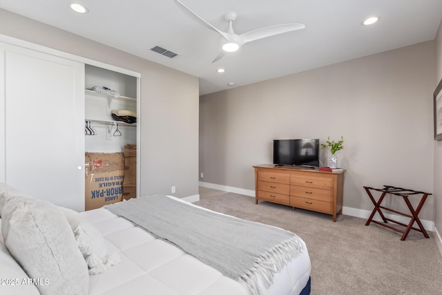 bedroom featuring light colored carpet, a closet, and ceiling fan