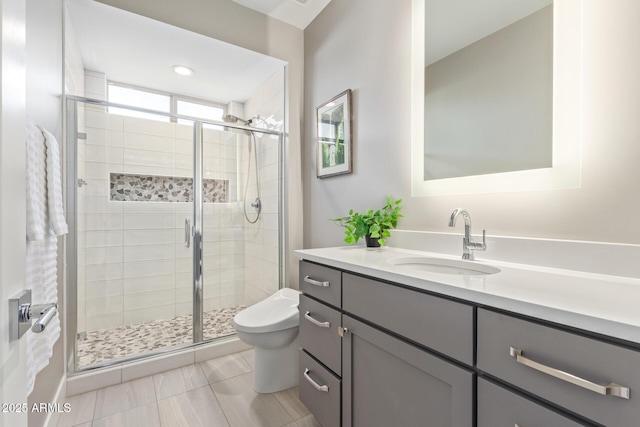 bathroom featuring vanity, tile patterned flooring, a shower with shower door, and toilet