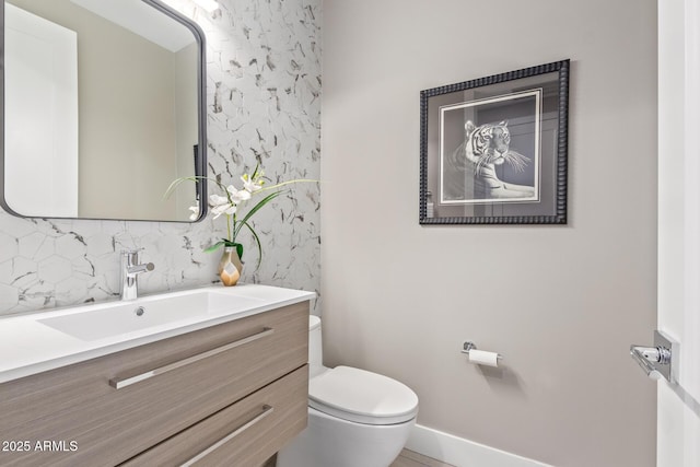 bathroom with vanity, tasteful backsplash, and toilet