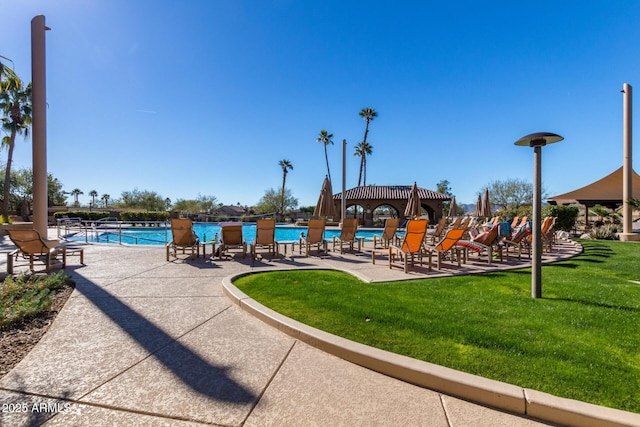 view of property's community with a yard and a swimming pool