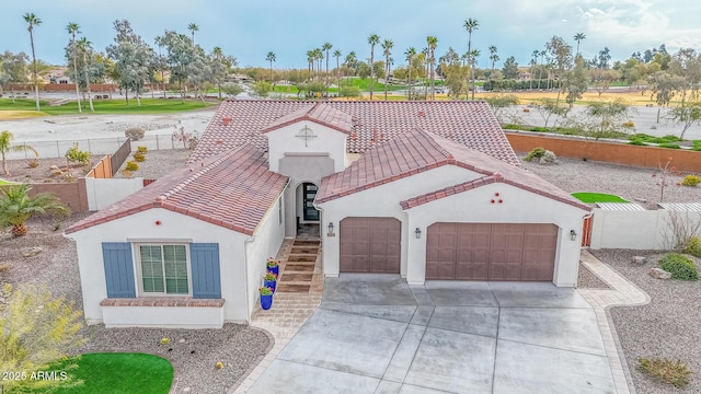 mediterranean / spanish house with a garage