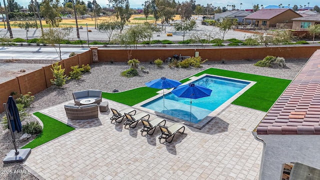 view of pool with outdoor lounge area and a patio