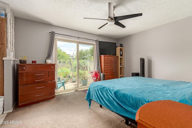 bedroom featuring access to exterior, ceiling fan, light carpet, and a textured ceiling