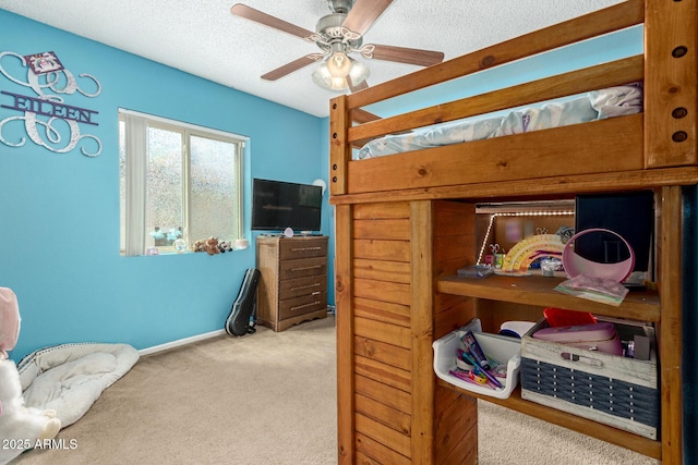 bedroom featuring baseboards, a ceiling fan, carpet flooring, and a textured ceiling