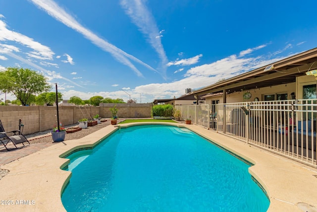 view of swimming pool featuring a fenced in pool, a patio, and a fenced backyard