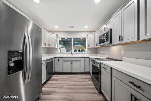 kitchen with gray cabinetry, appliances with stainless steel finishes, and recessed lighting
