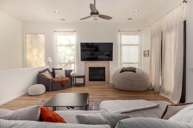 living room featuring light hardwood / wood-style flooring and ceiling fan