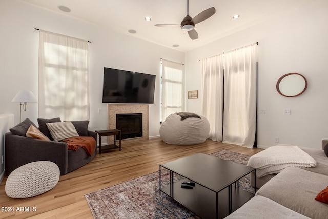 living room with ceiling fan and light wood-type flooring