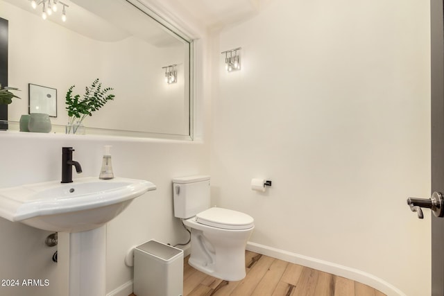 bathroom featuring hardwood / wood-style flooring and toilet