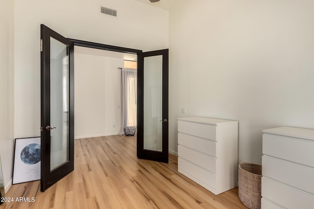 bedroom featuring light hardwood / wood-style flooring and french doors