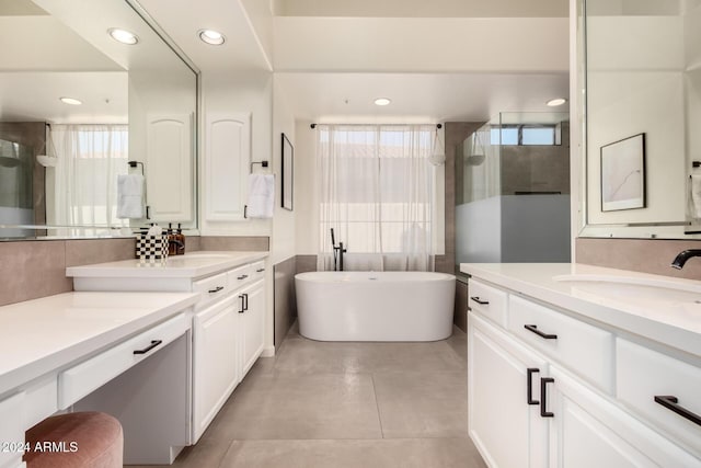 bathroom featuring vanity, tile patterned flooring, and independent shower and bath