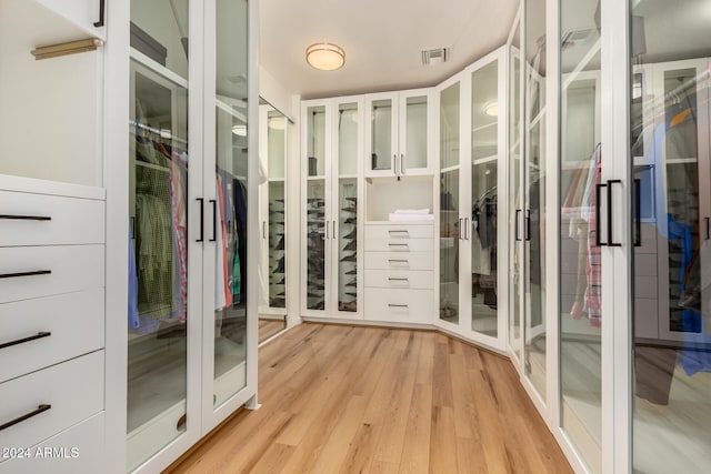 walk in closet featuring light hardwood / wood-style flooring