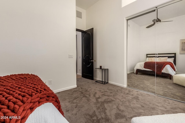 bedroom featuring ceiling fan, a closet, a high ceiling, and carpet